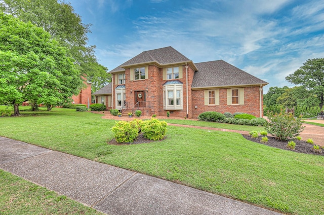 145 Dekewood Dr, Old Hickory, TN 37138 - view of front facade with brick siding, a front yard, and roof with shingles