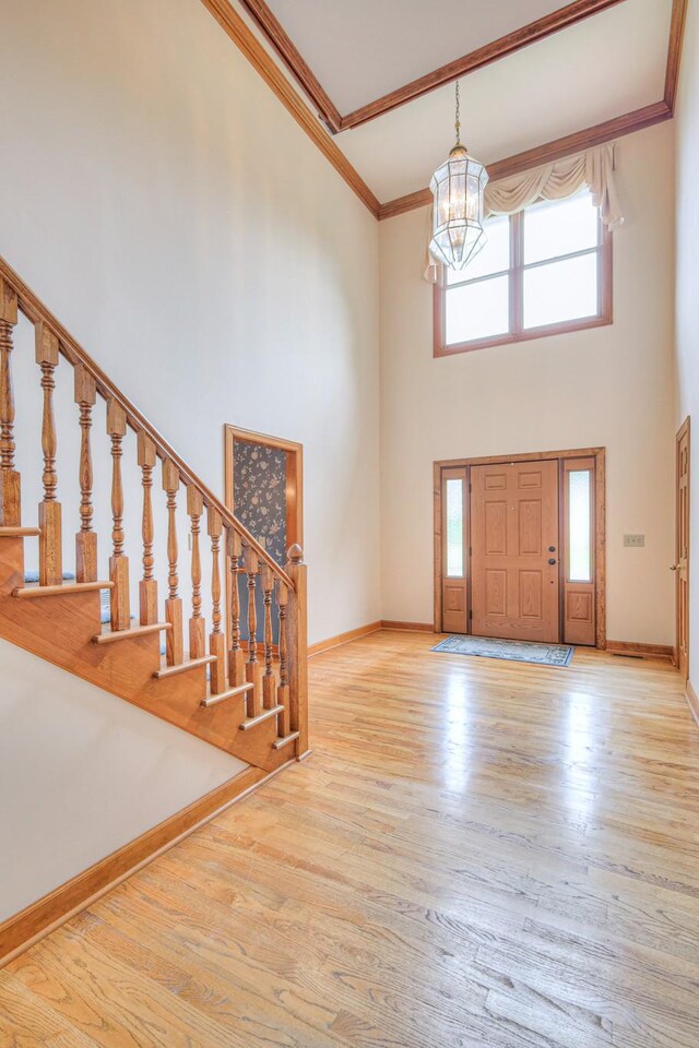 145 Dekewood Dr, Old Hickory, TN 37138 - entryway featuring a towering ceiling, a chandelier, healthy amount of natural light, wood finished floors, and ornamental molding