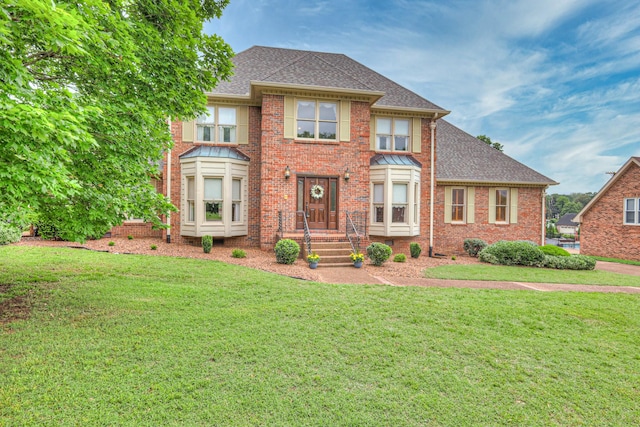 145 Dekewood Dr, Old Hickory, TN 37138 - view of front facade featuring roof with shingles, a front yard, and brick siding