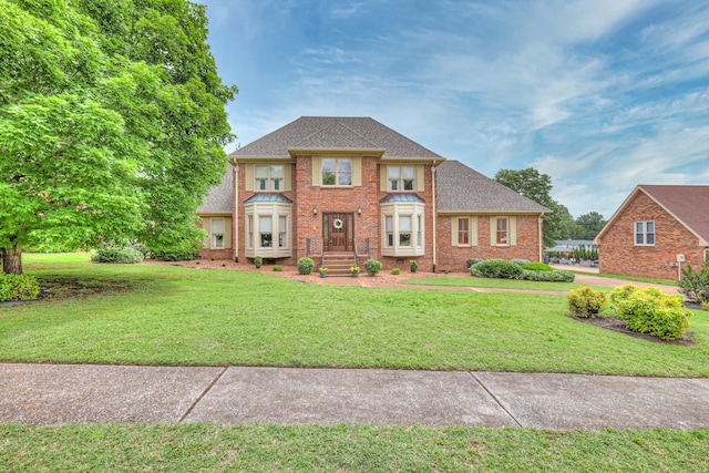 145 Dekewood Dr, Old Hickory, TN 37138 - view of front of house featuring a front yard, brick siding, and roof with shingles
