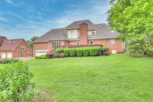 145 Dekewood Dr, Old Hickory, TN 37138 - rear view of property with brick siding, a lawn, driveway, and a wooden deck