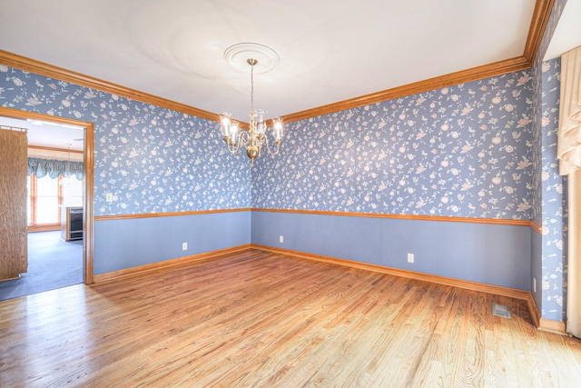 145 Dekewood Dr, Old Hickory, TN 37138 - unfurnished room with wallpapered walls, wood finished floors, ornamental molding, a chandelier, and baseboards