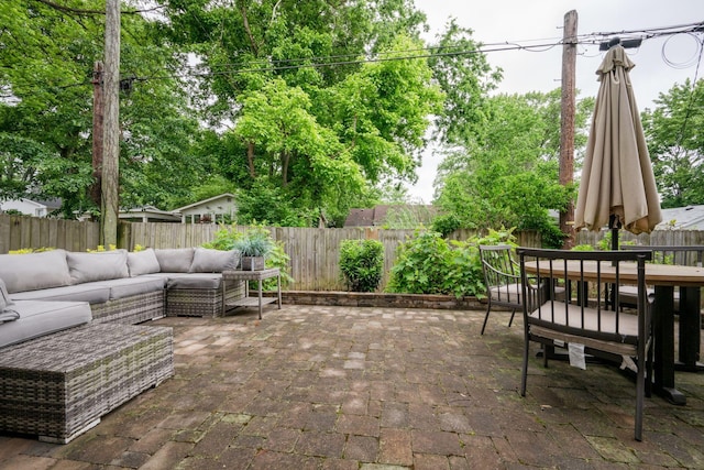 view of patio with an outdoor hangout area, a fenced backyard, and outdoor dining space