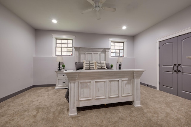 bedroom with light colored carpet, multiple windows, baseboards, and recessed lighting