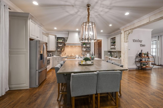 dining room featuring dark wood finished floors, crown molding, recessed lighting, and a chandelier