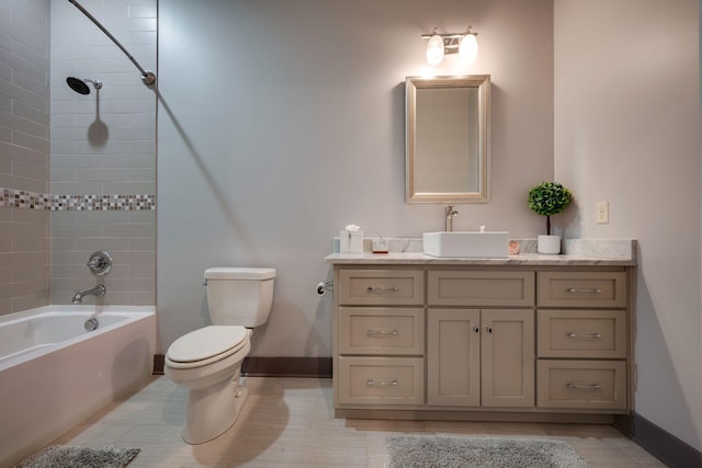 bathroom featuring baseboards, toilet, washtub / shower combination, and vanity