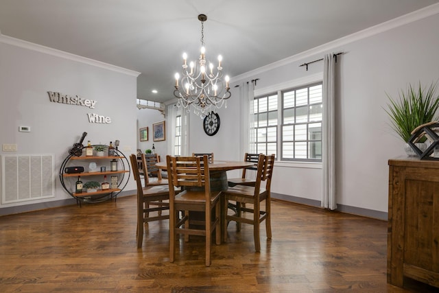 dining space with crown molding, a chandelier, dark wood-style flooring, and baseboards