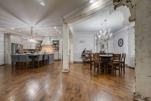 dining area with a chandelier, crown molding, dark wood finished floors, and recessed lighting