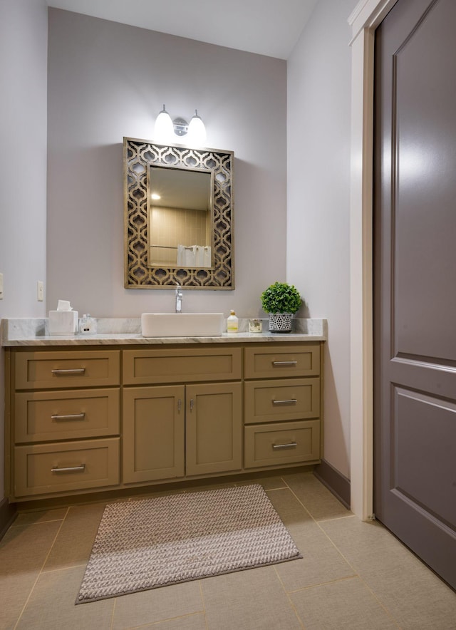bathroom with vanity, tile patterned floors, and baseboards