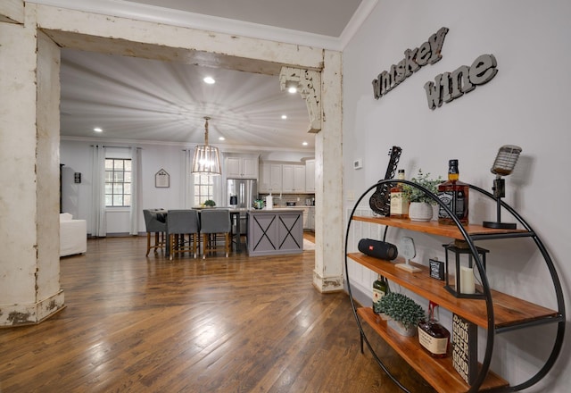 dining area featuring ornamental molding, wood finished floors, a chandelier, and recessed lighting