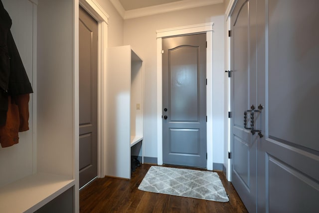 mudroom with dark wood finished floors, crown molding, and baseboards