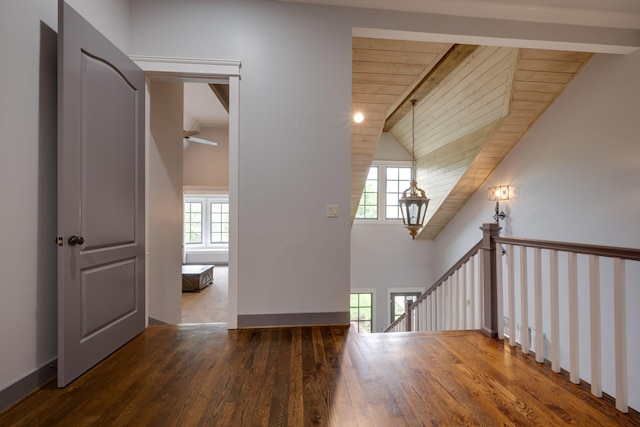 additional living space featuring wood finished floors, vaulted ceiling, and ceiling fan