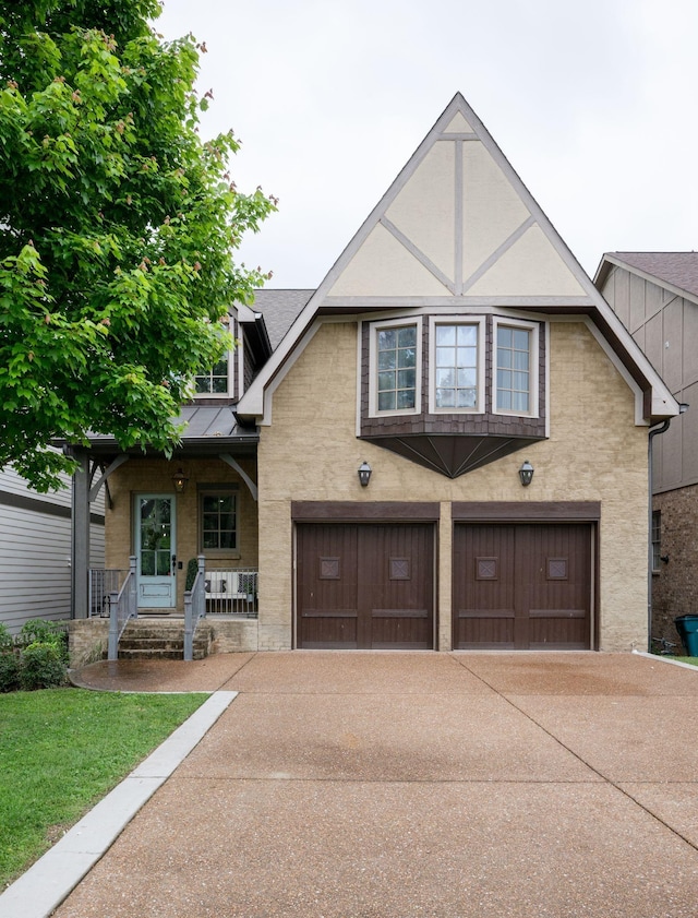 view of front of property featuring a garage, driveway, covered porch, and stucco siding