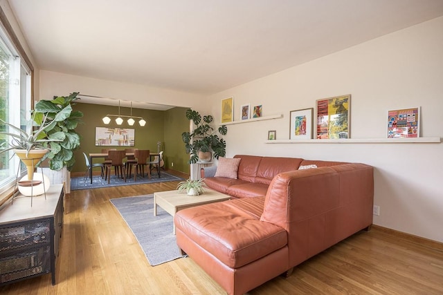 2413 Dundee Ln, Nashville, TN 37214 - living room featuring wood finished floors, baseboards, and a chandelier