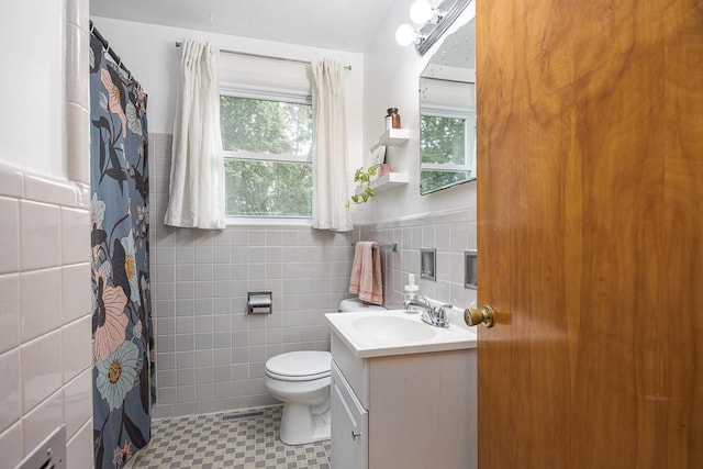 2413 Dundee Ln, Nashville, TN 37214 - bathroom featuring tile walls, toilet, vanity, healthy amount of natural light, and a shower with shower curtain