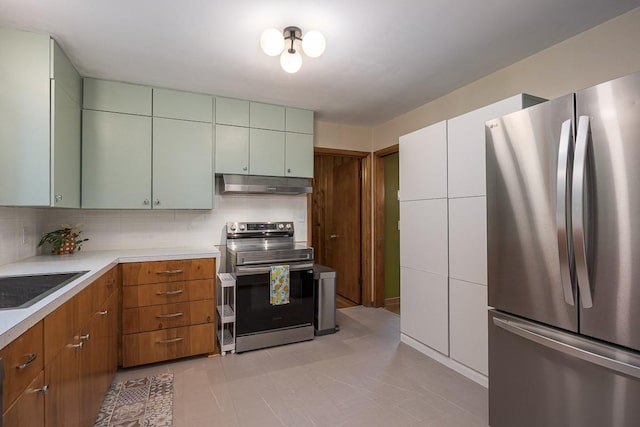 2413 Dundee Ln, Nashville, TN 37214 - kitchen featuring appliances with stainless steel finishes, under cabinet range hood, light countertops, backsplash, and a sink
