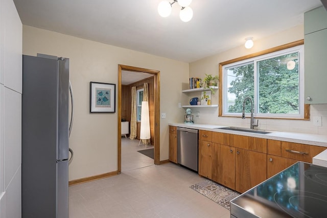 2413 Dundee Ln, Nashville, TN 37214 - kitchen with stainless steel appliances, a sink, light countertops, and tasteful backsplash