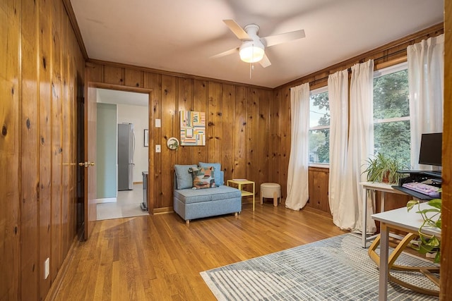 2413 Dundee Ln, Nashville, TN 37214 - living area with wooden walls, a ceiling fan, light wood-type flooring, and crown molding