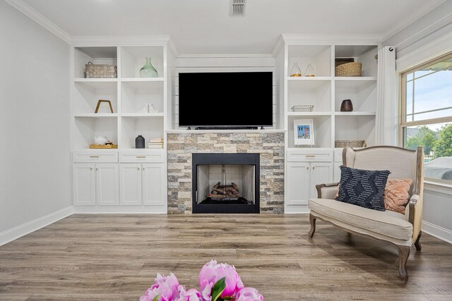 1006 Brinxton Run, Murfreesboro, TN 37128 - living room featuring wood finished floors, baseboards, crown molding, a stone fireplace, and built in features