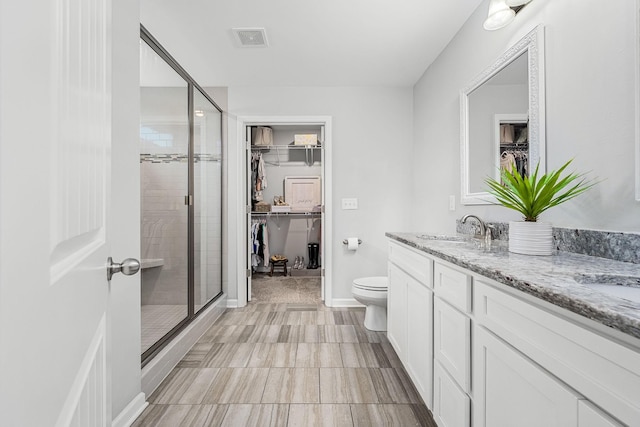 1006 Brinxton Run, Murfreesboro, TN 37128 - bathroom with a shower stall, a spacious closet, double vanity, and toilet