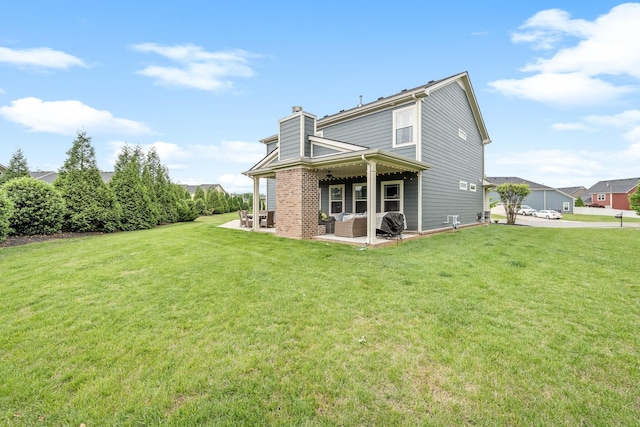 1006 Brinxton Run, Murfreesboro, TN 37128 - back of house featuring a chimney, an outdoor hangout area, a patio area, and a lawn