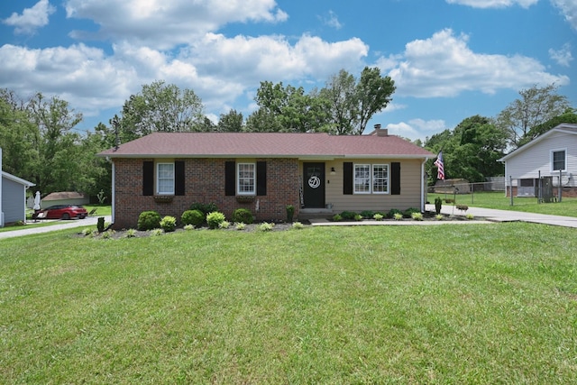 ranch-style home featuring a chimney and brick siding