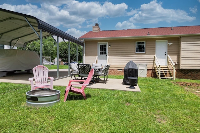 rear view of property with entry steps, a chimney, a yard, crawl space, and a detached carport