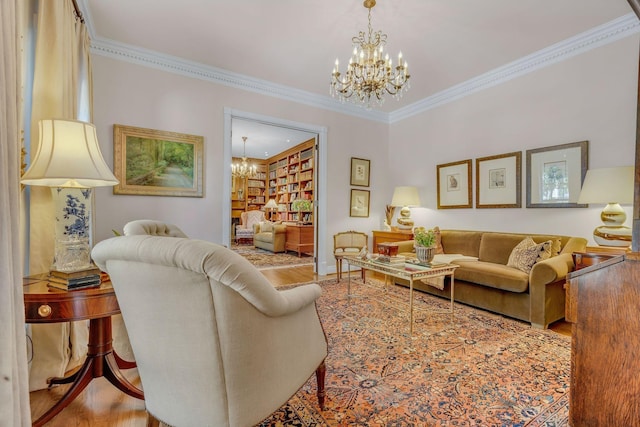 living area with a chandelier, wood finished floors, ornamental molding, and baseboards