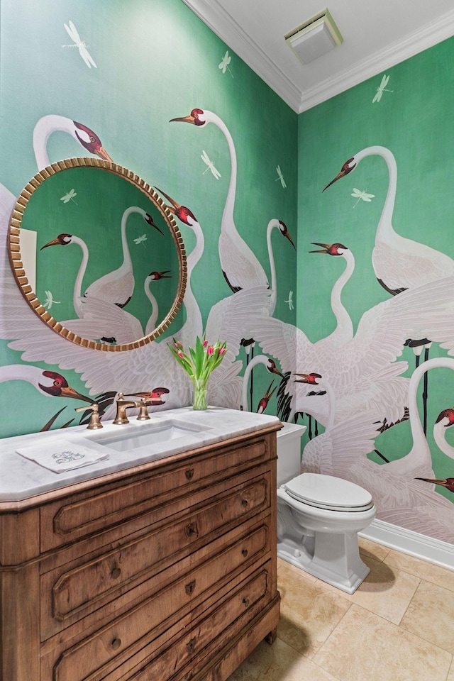 bathroom with ornamental molding, toilet, and vanity