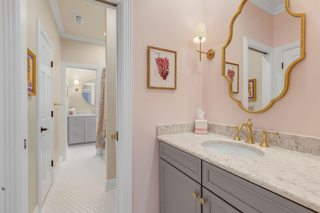 bathroom with crown molding, vanity, tile patterned floors, and baseboards