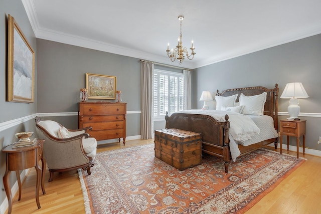 bedroom featuring a chandelier, wood finished floors, ornamental molding, and baseboards