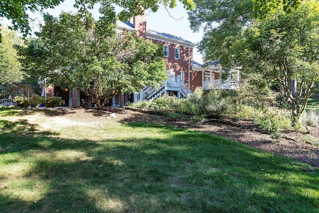 view of green lawn with stairs