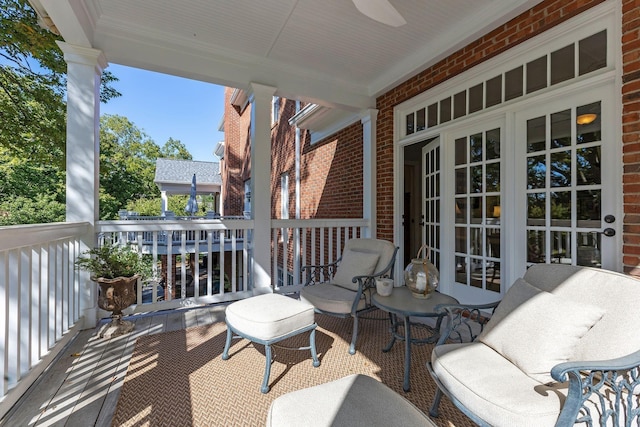 balcony with covered porch and ceiling fan