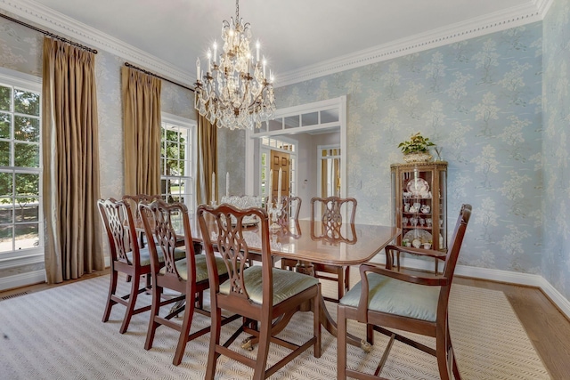 dining area featuring a chandelier, light wood-type flooring, and ornamental molding