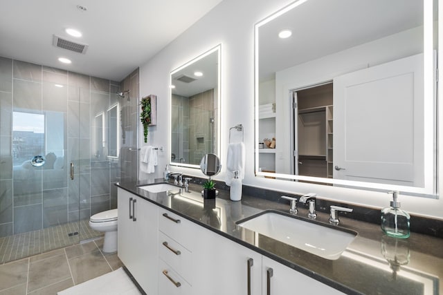 bathroom with a stall shower, toilet, double vanity, tile patterned flooring, and recessed lighting