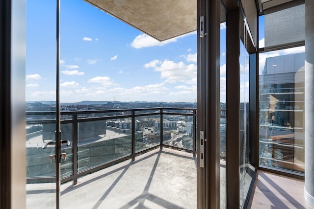 balcony featuring a mountain view and a view of city