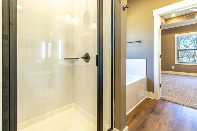1203 Goose Dr, Springfield, TN 37172 - bathroom featuring a stall shower, a garden tub, wood finished floors, and baseboards