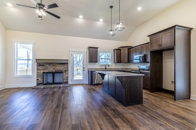 1203 Goose Dr, Springfield, TN 37172 - kitchen with stainless steel appliances, lofted ceiling, dark brown cabinets, a kitchen island, and open floor plan