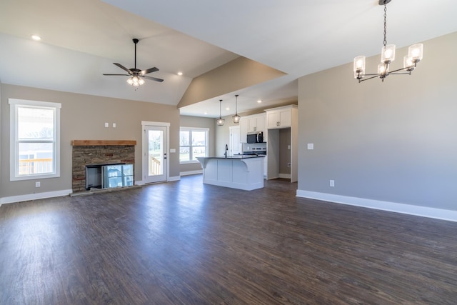 1137 Goose Dr, Springfield, TN 37172 - unfurnished living room featuring vaulted ceiling, a chandelier, dark wood-style flooring, baseboards, and ceiling fan