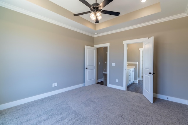 1137 Goose Dr, Springfield, TN 37172 - unfurnished bedroom with a tray ceiling, dark carpet, crown molding, and baseboards