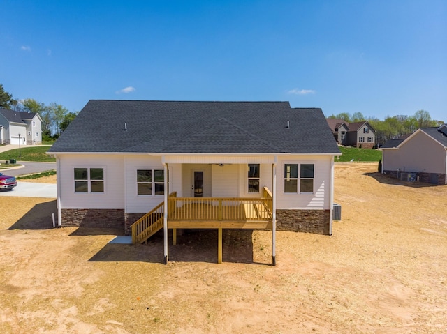 1137 Goose Dr, Springfield, TN 37172 - rear view of property with a shingled roof, stone siding, a deck, and a residential view