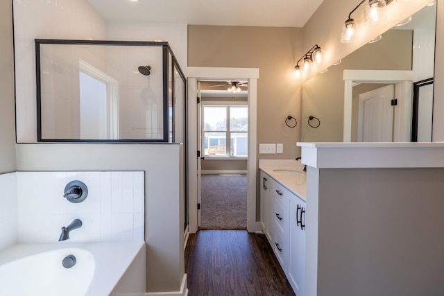 1137 Goose Dr, Springfield, TN 37172 - full bath featuring a stall shower, wood finished floors, a garden tub, vanity, and ceiling fan