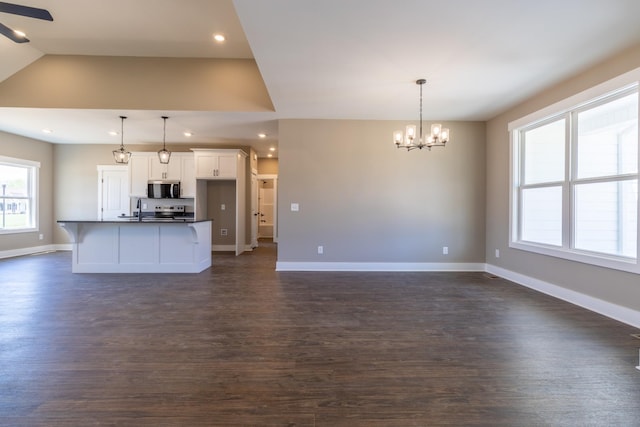 1137 Goose Dr, Springfield, TN 37172 - unfurnished living room featuring a chandelier, dark wood-style floors, baseboards, a ceiling fan, and recessed lighting