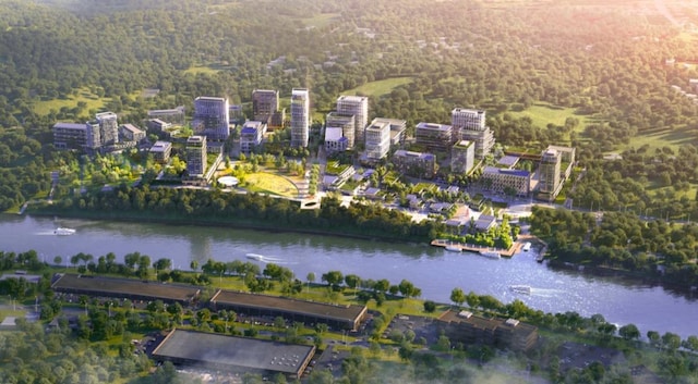 view of property location featuring a nearby body of water and a forest