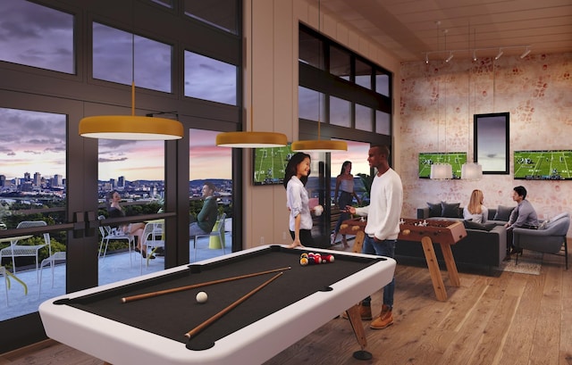 game room featuring track lighting, wood finished floors, billiards table, and a view of city