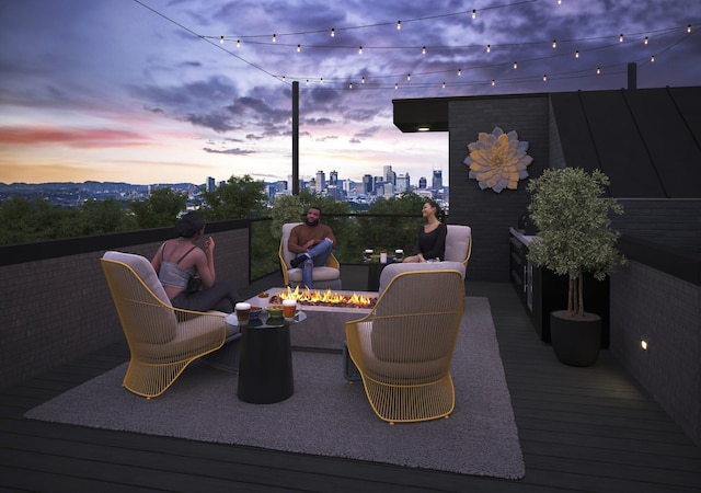 wooden deck featuring an outdoor fire pit and a skyline view