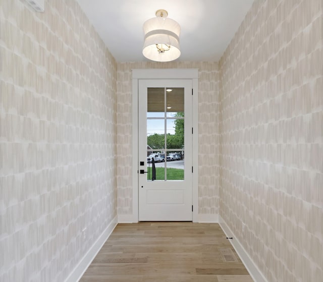 entryway featuring light wood-style floors and baseboards