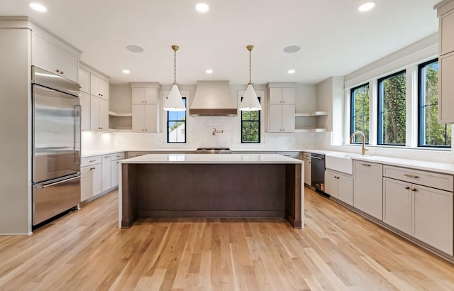 kitchen with open shelves, appliances with stainless steel finishes, custom exhaust hood, a sink, and recessed lighting