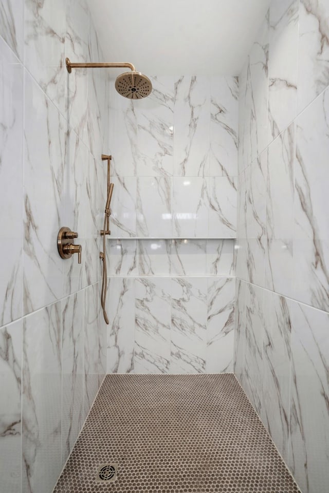 bathroom with a tile shower