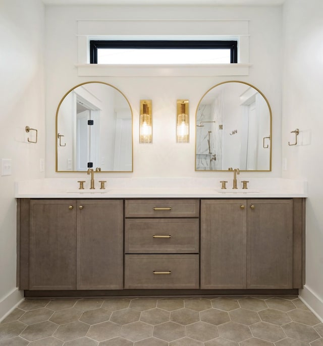 bathroom featuring baseboards, healthy amount of natural light, vanity, and a shower